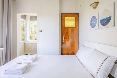 a white bedroom with a large white bed and a window at Spacious 4BR Home - Stunning Bosphorus Views! #390 in Istanbul