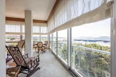 a living room with a table and chairs and large windows at Spacious 4BR Home - Stunning Bosphorus Views! #390 in Istanbul