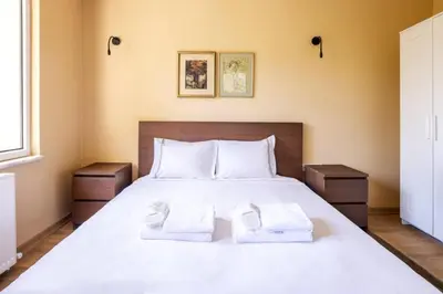 a bedroom with a bed with two towels on it at Charming New 1BD Home - Close to Shoreline! #395 in Sarıyer