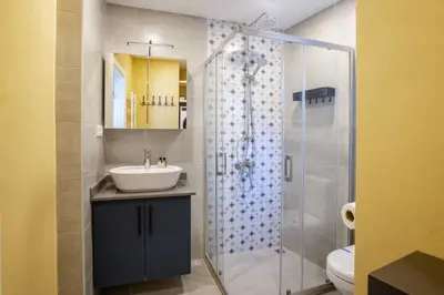 a bathroom with a sink and a glass shower at Charming New 1BD Home - Close to Shoreline! #395 in Sarıyer