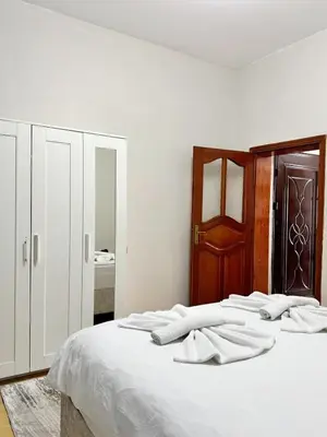 a white bed with white towels on top of it at Apartment Taksim-Beyoğlu 2 in Istanbul