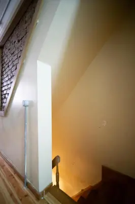 a staircase in a building with a light shining on the wall at Mercan Apartments Balat - Mihrab Niche in Istanbul