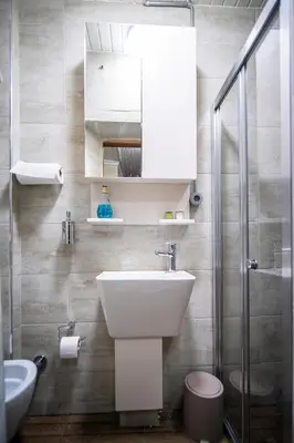 a bathroom with a sink and a toilet and a mirror at Mercan Apartments Balat - Mihrab Niche in Istanbul