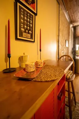 a counter with two red candles on top of it at Mercan Apartments Balat-The Bay in Istanbul