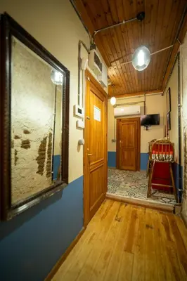 a hallway with a door and a chair in a room at Mercan Apartments Balat-The Bay in Istanbul