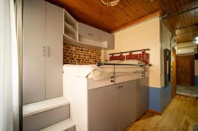 a small room with white cabinets and a bunk bed at Mercan Apartments Balat-The Bay in Istanbul