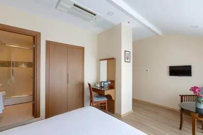 a bedroom with a bed and a desk and a tv at Lalahan Hotel in Istanbul