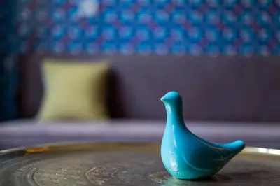a blue vase sitting on top of a plate at Lalahan Hotel in Istanbul
