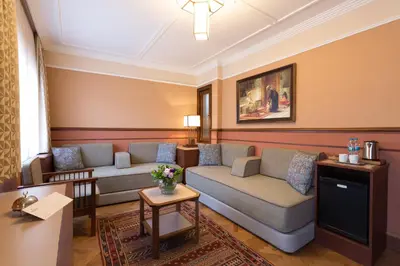 a living room with two couches and a table at Lalahan Hotel in Istanbul