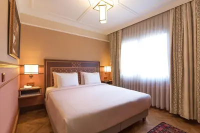 a bedroom with a large bed and a window at Lalahan Hotel in Istanbul