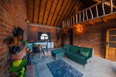 a living room with a green couch and a brick wall at oasis sapanca in Sapanca