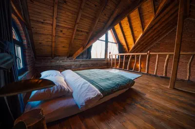 a bed in a room with a wooden ceiling at oasis sapanca in Sapanca