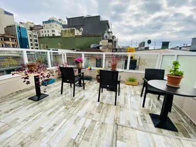 a rooftop patio with tables and chairs on a building at T & R İstanbul hotel in Istanbul