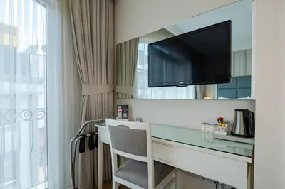a hotel room with a desk and a tv at T & R İstanbul hotel in Istanbul