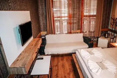 a living room with a couch and a flat screen tv at Pablo suit otel in Istanbul
