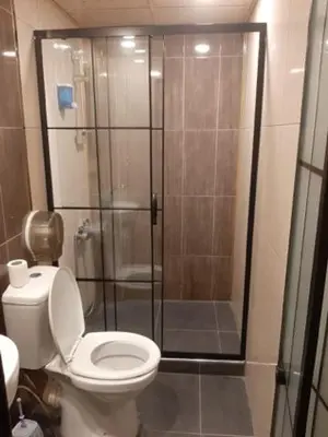 a bathroom with a toilet and a glass shower at Pablo suit otel in Istanbul