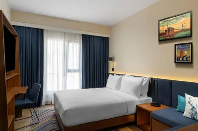 a hotel room with a bed and a couch at Hampton By Hilton Istanbul Sisli in Istanbul