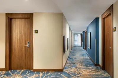 a corridor of a hotel with blue and white walls at Hampton By Hilton Istanbul Sisli in Istanbul