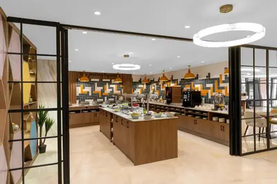 a large kitchen with a counter in a restaurant at Hampton By Hilton Istanbul Sisli in Istanbul