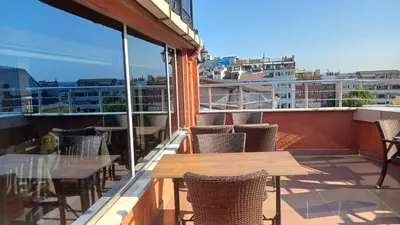 a patio with tables and chairs on a balcony at Hotel Çağyiğit in Istanbul