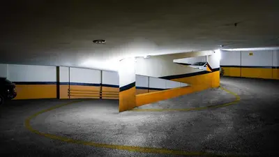 an empty parking garage with yellow and blue walls at The Grand Mira Business Hotel in Istanbul