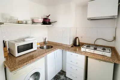 a small kitchen with a microwave and a sink at Istanberry - Joker Two Bedroom Apartments in Istanbul