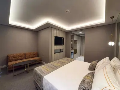 a bedroom with a large bed and a tv at Saygın Hotel Beşiktaş in Istanbul