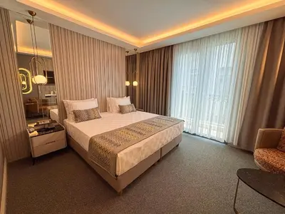 a bedroom with a large bed and a large window at Saygın Hotel Beşiktaş in Istanbul