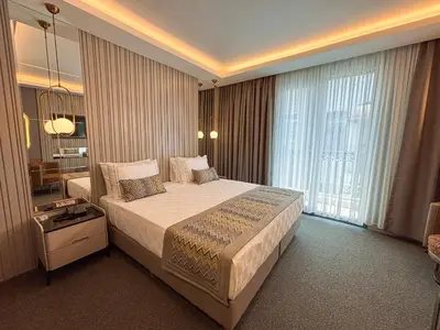 a bedroom with a large bed and a large window at Saygın Hotel Beşiktaş in Istanbul