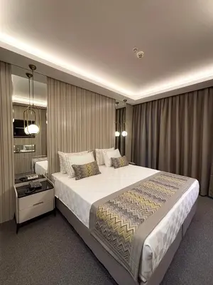 a bedroom with a large bed in a room at Saygın Hotel Beşiktaş in Istanbul