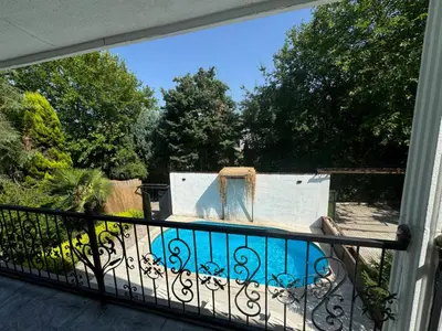 a balcony with a view of a swimming pool at Sapanca Bizim Konak in Sapanca