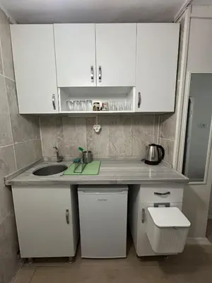 a kitchen with white cabinets and a sink at i1 House Hotel with Lovely Seaview Terrace in Istanbul