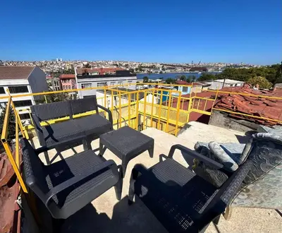 a group of chairs and tables on top of a roof at i1 House Hotel with Lovely Seaview Terrace in Istanbul