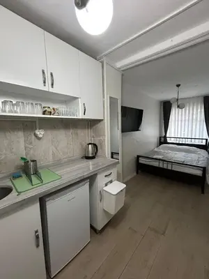 a kitchen with a sink and a bed in a room at i1 House Hotel with Lovely Seaview Terrace in Istanbul