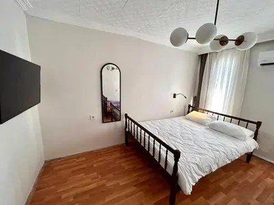 a bedroom with a bed and a mirror at i1 House Hotel with Lovely Seaview Terrace in Istanbul