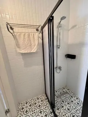 a bathroom with a shower with a glass door at i1 House Hotel with Lovely Seaview Terrace in Istanbul