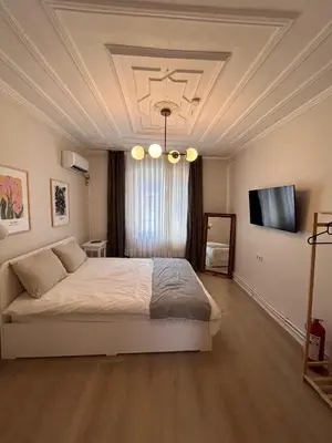 a bedroom with a large bed with a coffered ceiling at i1 House Hotel with Lovely Seaview Terrace in Istanbul