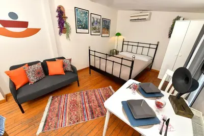 a living room with a couch and a bed at Cute Home Balcony Retro Design AC Galata in Istanbul
