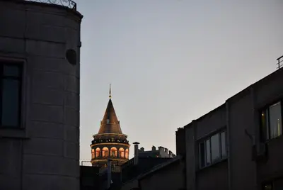 a building with a steeple with lights on it at Cute Home Balcony Retro Design AC Galata in Istanbul