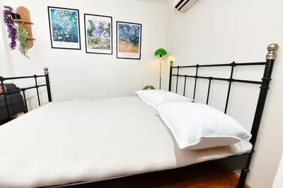 a bedroom with a black bed with white pillows at Cute Home Balcony Retro Design AC Galata in Istanbul