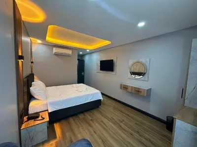 a small room with a bed and a tv at Dual Hotel Halkalı in Istanbul