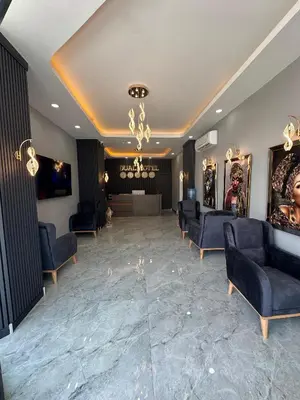 a waiting room with couches and a chandelier at Dual Hotel Halkalı in Istanbul