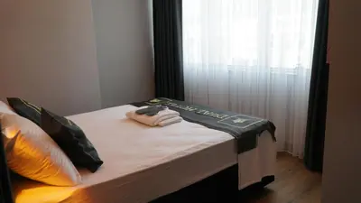 a bed with a remote control on top of it at Dual Hotel Halkalı in Istanbul