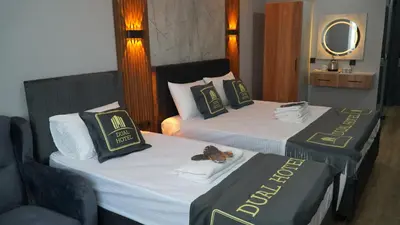 a hotel room with two beds and a mirror at Dual Hotel Halkalı in Istanbul