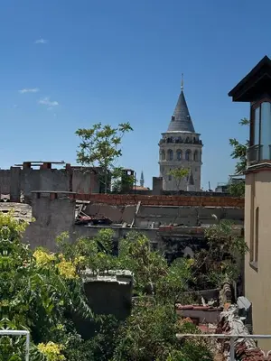 a view of a building with a tower in the background at Galata Tower Suites in Istanbul