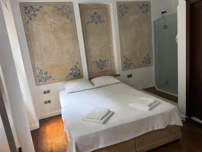 a bedroom with a white bed with two towels on it at Galata Tower Suites in Istanbul
