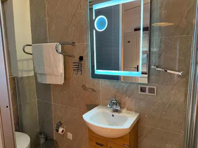 a bathroom with a sink and a mirror at Galata Tower Suites in Istanbul