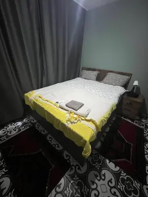 a bedroom with a bed with a yellow blanket on it at Murat bey konağı in Istanbul