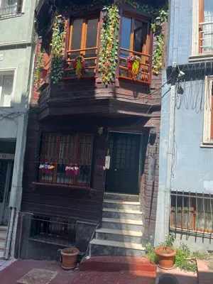 a house with flowers on the balconies and stairs at Murat bey konağı in Istanbul