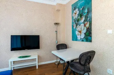 a living room with a table and a tv at Equipped Flat w Balcony - In The Arnavutköy - Bebek in Istanbul